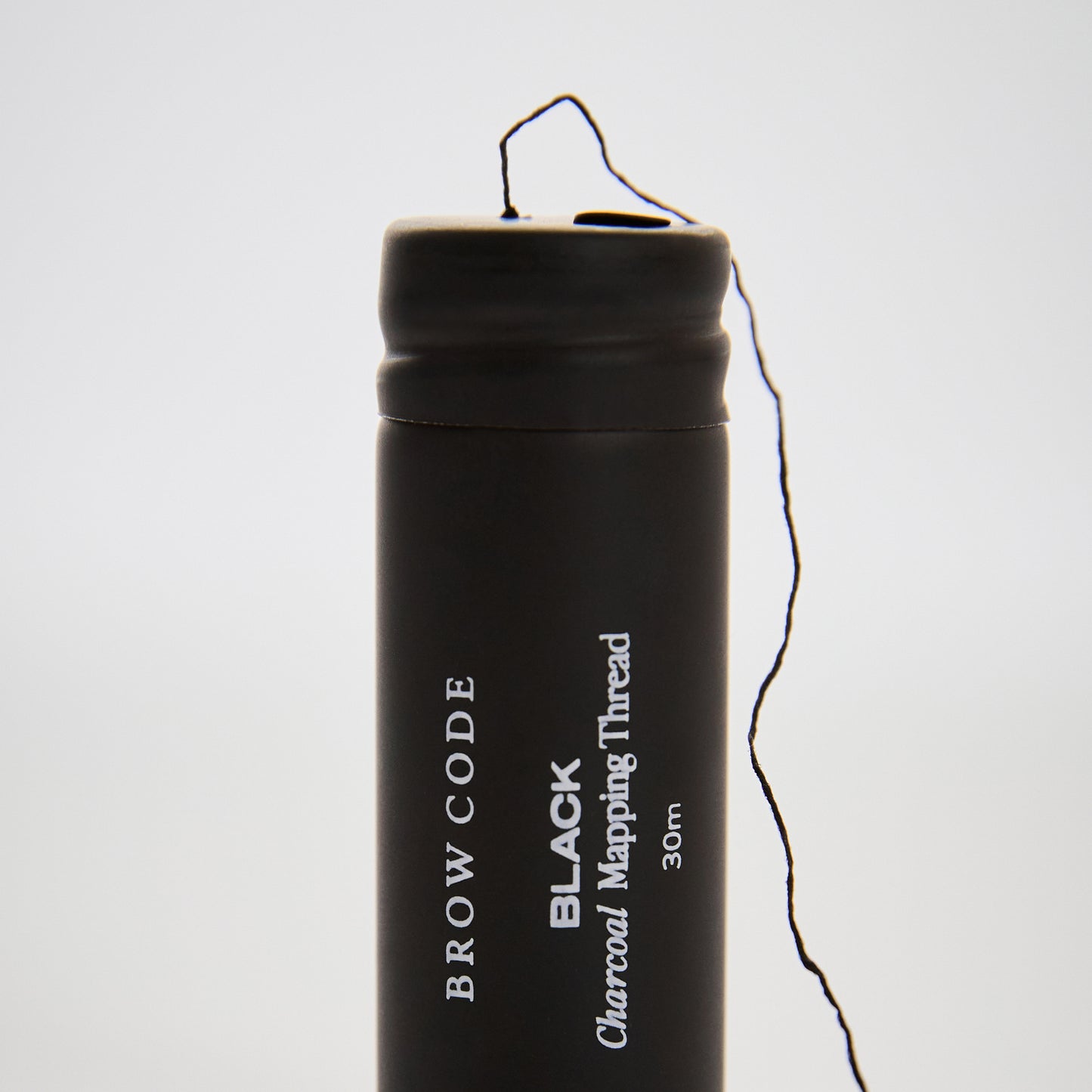 Charcoal_Brow_Mapping_Thread_Packaging standing up with thread coming out-color-black